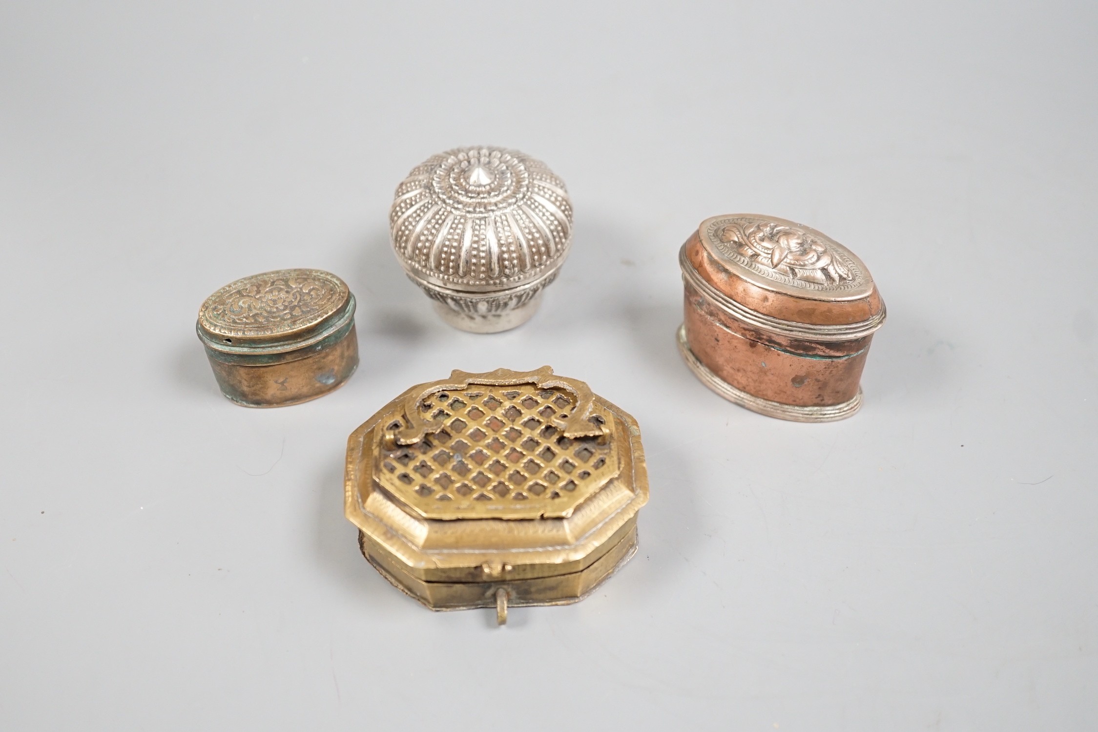 Four southeast Asian metal Betel nut containers, largest 7.5 cm